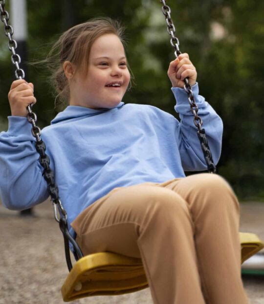 happy-child-with-down-syndrome-playing-outside-scaled-1.jpg